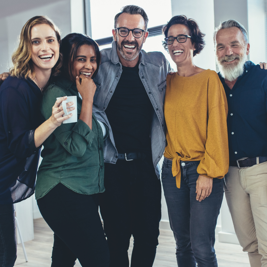 A group of community members and colleagues smiling for a picture