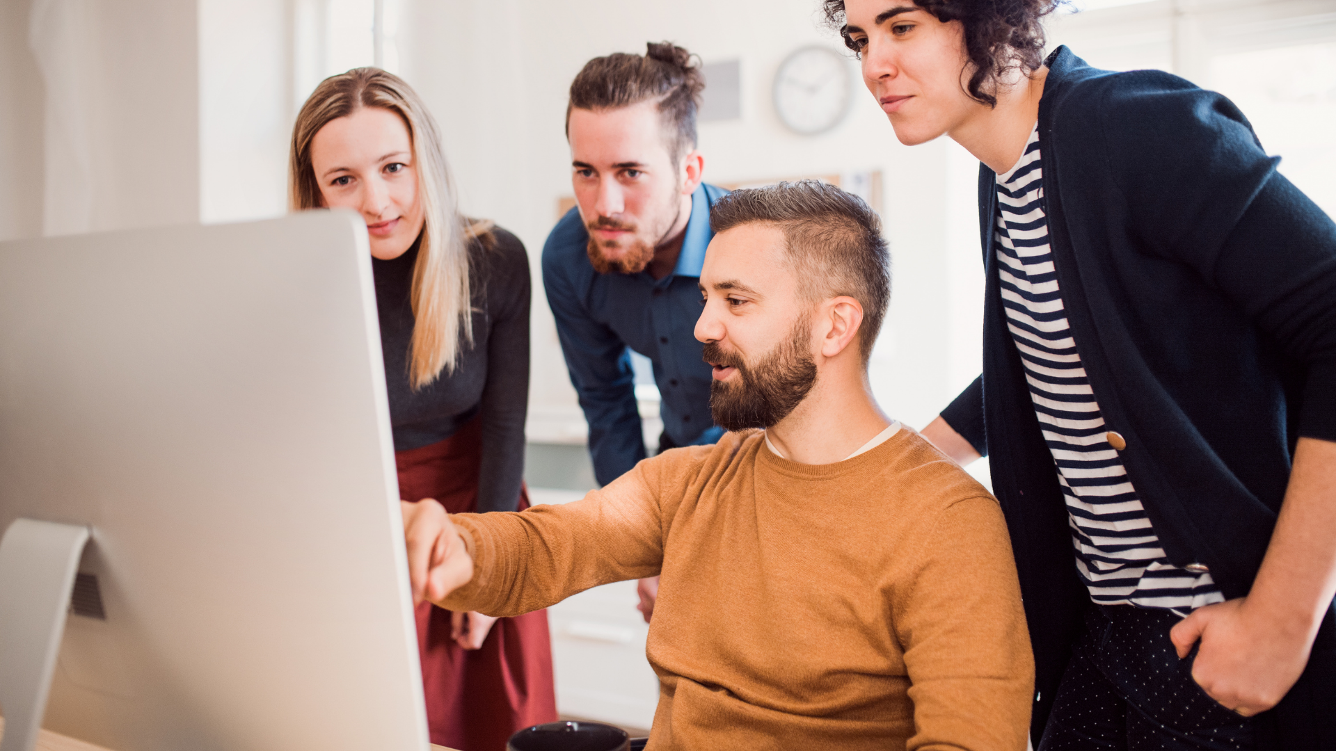 Man showing multiple individuals content on a computer