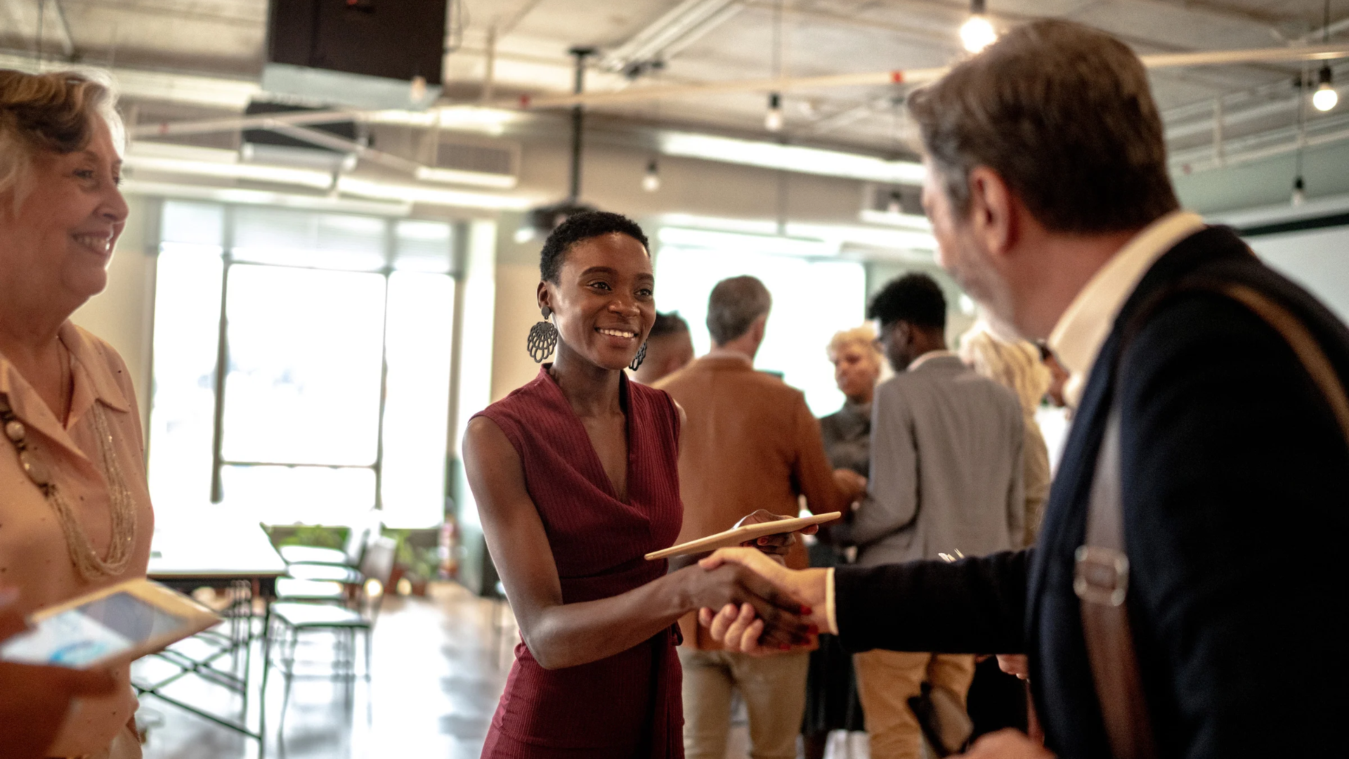 Woman shaking hands with a man at a business event