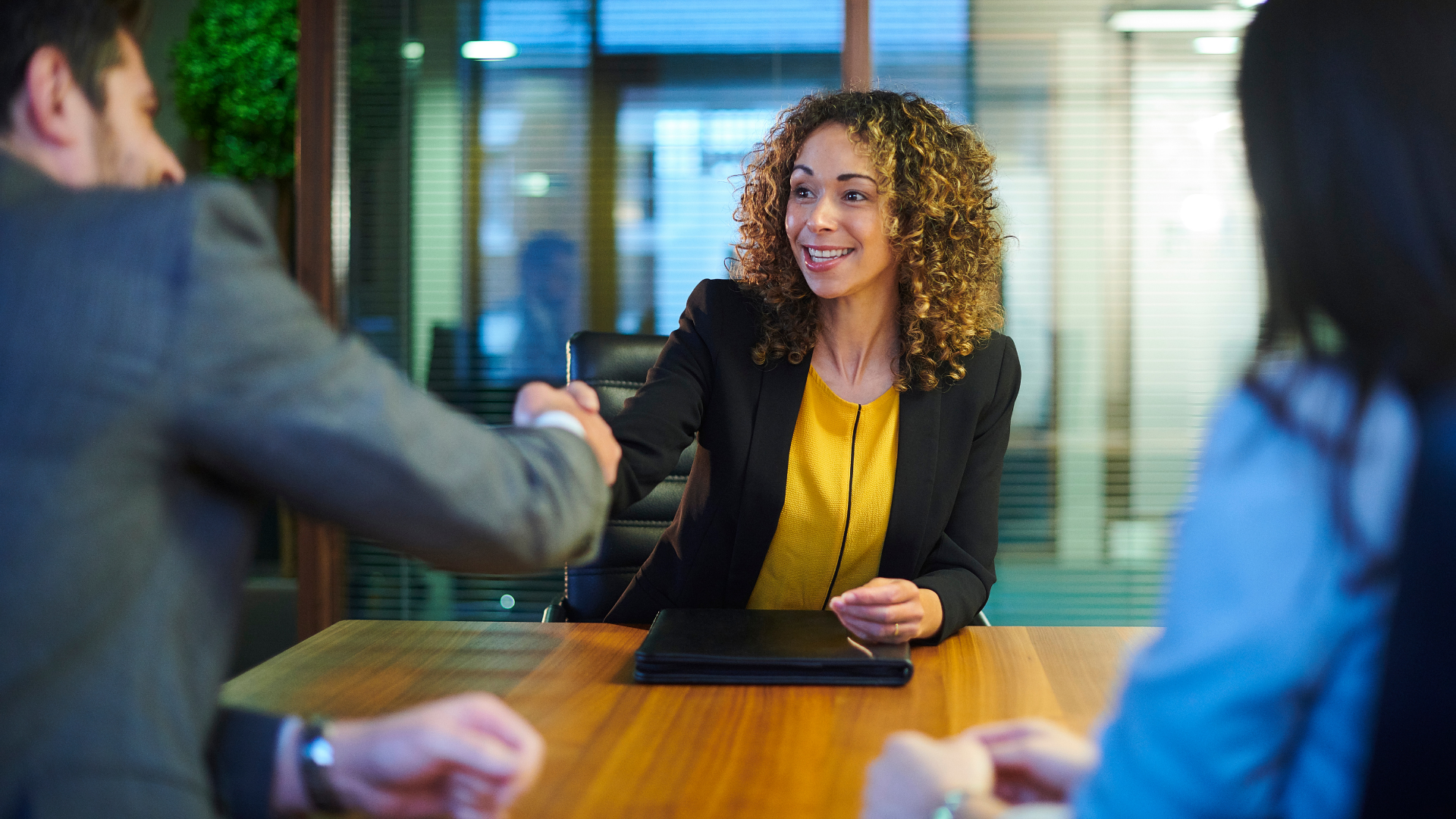 Woman shaking hands with hiring manager at an interview