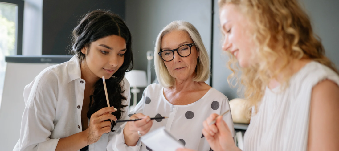 Women discussing work duties with a mentor